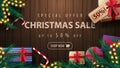 Special offer, Christmas sale, up to 50% off, discount banner with wooden background, garland, Christmas tree branches, presents Royalty Free Stock Photo