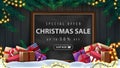 Special offer, Christmas sale, up to 50% off, discount banner with wooden wall, Christmas tree branches, garland, chalk board .