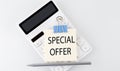 SPECIAL OFFER text on the sticker on white calculator