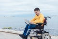 a special person with disabilities with a laptop at sea Royalty Free Stock Photo