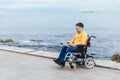 a special person with disabilities with a laptop at sea Royalty Free Stock Photo