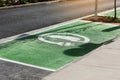 Special place for charging electric cars or vehicles. Green E- Car charging station sign in a parking bay. Modern and Royalty Free Stock Photo