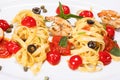 Special shrimp pasta dish made by restaurant chef with tomatoes and olives shot on white background Royalty Free Stock Photo