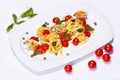 Special shrimp pasta dish made by restaurant chef with tomatoes and olives shot on white background Royalty Free Stock Photo