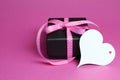 Special small black box present gift with pink polka dot ribbon and white heart shape gift tag