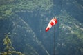 special sock with red and white stripes for measuring wind strength and direction is installed on airfields and runways Royalty Free Stock Photo