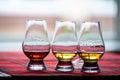 Special tulip-shaped glasses for tasting of Scotch whisky on distillery in Scotland, UK and red tartan