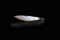 A special turkish knife. testing the sharpness of the blade on the black floor. a small pocket knife, a small shepherd`s knife,