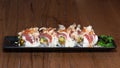 Special Uramaki with tuna, raw shrimps, omelette, cheese sauce, onions,.Tabasco, caviar and Katsuobushi