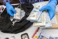 Specialised police officer Counting dollar banknotes in crime lab