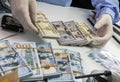 Specialised police officer Counting dollar banknotes in crime lab