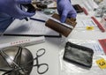 Specialised police officer measures wallet in crime lab Royalty Free Stock Photo