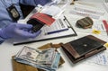 Specialised police officer takes wallet with money out of a murder evidence bag