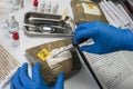 Specialised police open bundle of drugs in crime lab