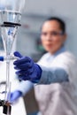 Specialist chemist woman working at biochemistry experiment using professional biology tools Royalty Free Stock Photo