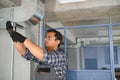 specialist cleans and repairs the wall air conditioner Royalty Free Stock Photo