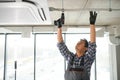 specialist cleans and repairs the wall air conditioner Royalty Free Stock Photo