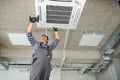 specialist cleans and repairs the wall air conditioner Royalty Free Stock Photo