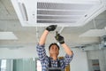 specialist cleans and repairs the wall air conditioner Royalty Free Stock Photo