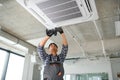 specialist cleans and repairs the wall air conditioner Royalty Free Stock Photo