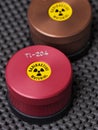 Specialist containers with warning sticker and engraving containing radioactive isotopes