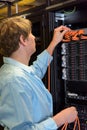 IT specialist controlling server in datacenter