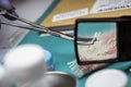 Specialist cop examines piece of blood-stained cloth belonging to murder victim