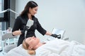 Specialist cosmetologist adjusts the device for a rejuvenating procedure
