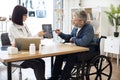 Specialist discussing x-ray image with wheelchair user