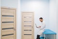 Specialist doctor in the corridor of his clinic with his laptop Royalty Free Stock Photo