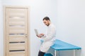 Specialist doctor in the corridor of his clinic with his laptop Royalty Free Stock Photo