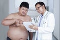 Specialist doctor with overweight patient Royalty Free Stock Photo