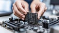 IT specialist hands inserting a RAM module into a slot on a computer motherboard during system upgrade or maintenance Royalty Free Stock Photo