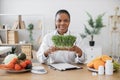 Specialist holding container with microgreens in workplace