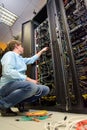 IT specialist installing cables in datacenter
