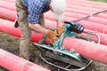 The specialist installs a welding machine for welding of plastic pipes. Polyethylene pipes for electric cables