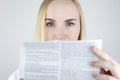 The doctor on a white background reads the instructions for medicines. The specialist looks at the list and composition of the