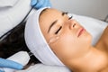 Specialist makes hardware vacuum facial massage to client