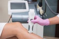 Specialist makes skin tone measurements on a womans leg Royalty Free Stock Photo
