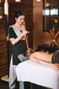 Young charming girl on a panchakarma procedure laying on a massage table. beautiful woman spending time at modern spa