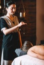 Young charming girl on a panchakarma procedure laying on a massage table. beautiful woman spending time at modern spa