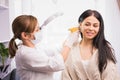 Specialist in medical mask and gloves pierces the client& x27;s ears with a piercing gun in the cosmetologist cabinet. Royalty Free Stock Photo