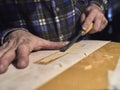 The specialist removes varnish from the body of the guitar.