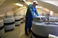 A specialist research institute in a protective mask and workwear works with liquid nitrogen, which is used in tanks to create Royalty Free Stock Photo