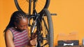 Specialist using screwdriver and hex socket wrench to secure wheel on bicycle Royalty Free Stock Photo