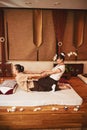 Specialist using Thai massage method of stretching client back Royalty Free Stock Photo