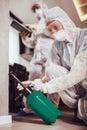 Specialists in protective suits do disinfection or pest control