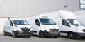 Specialized delivery society parking with several white small trucks van Royalty Free Stock Photo