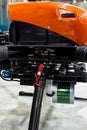specialized industrial drone with red body with suspension close-up, selective focus, depth of field