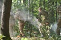 A specialized military antiterrorist unit conducts a covert operation in dense, hazardous woodland, demonstrating Royalty Free Stock Photo